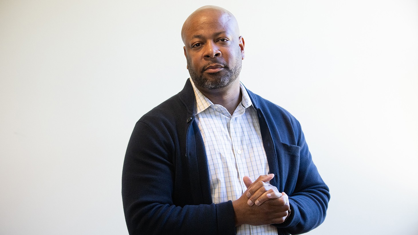 Portrait of manager Ed Green clasping his hands