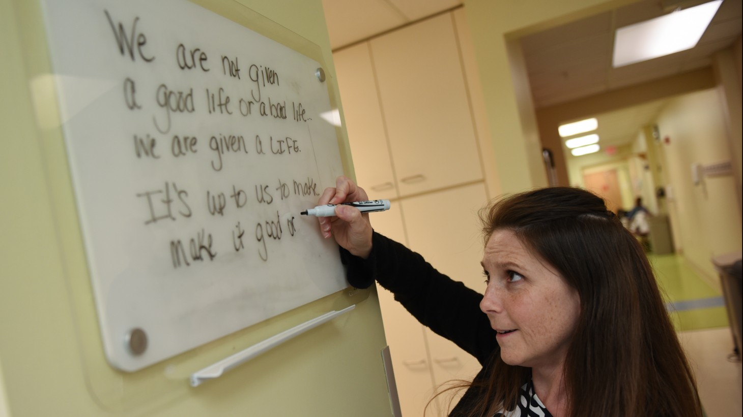 Woman writes on board