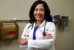 woman physican in white jacket arms crossed