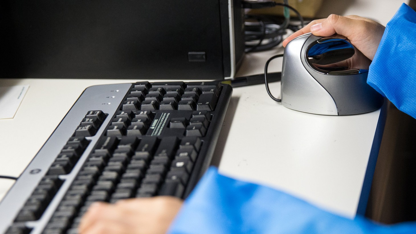 hands on a computer keyboard and mouse