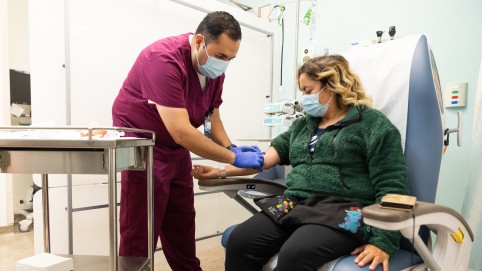 Nurse preparing to take blood from patient