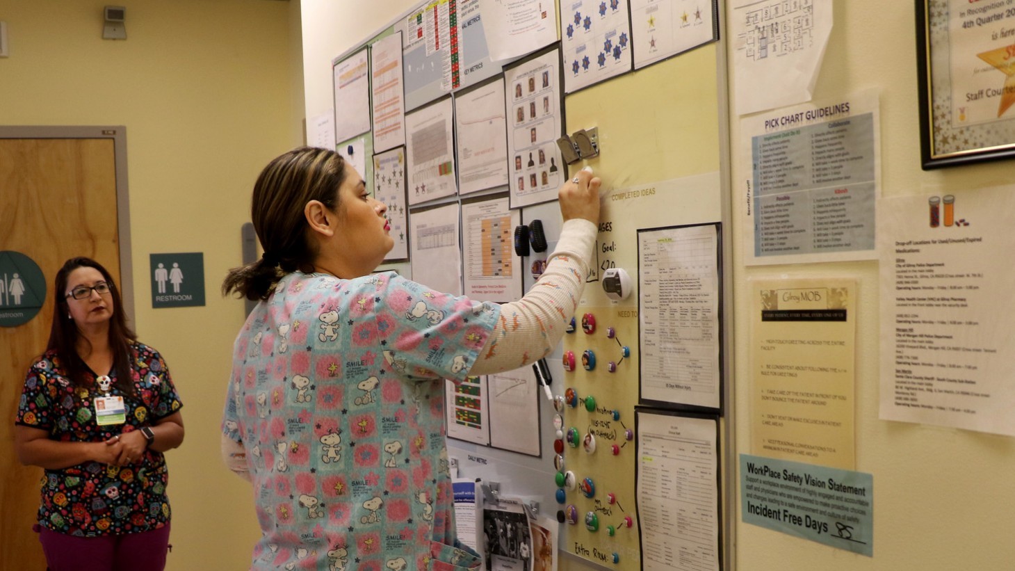 A team member records data on a visual board